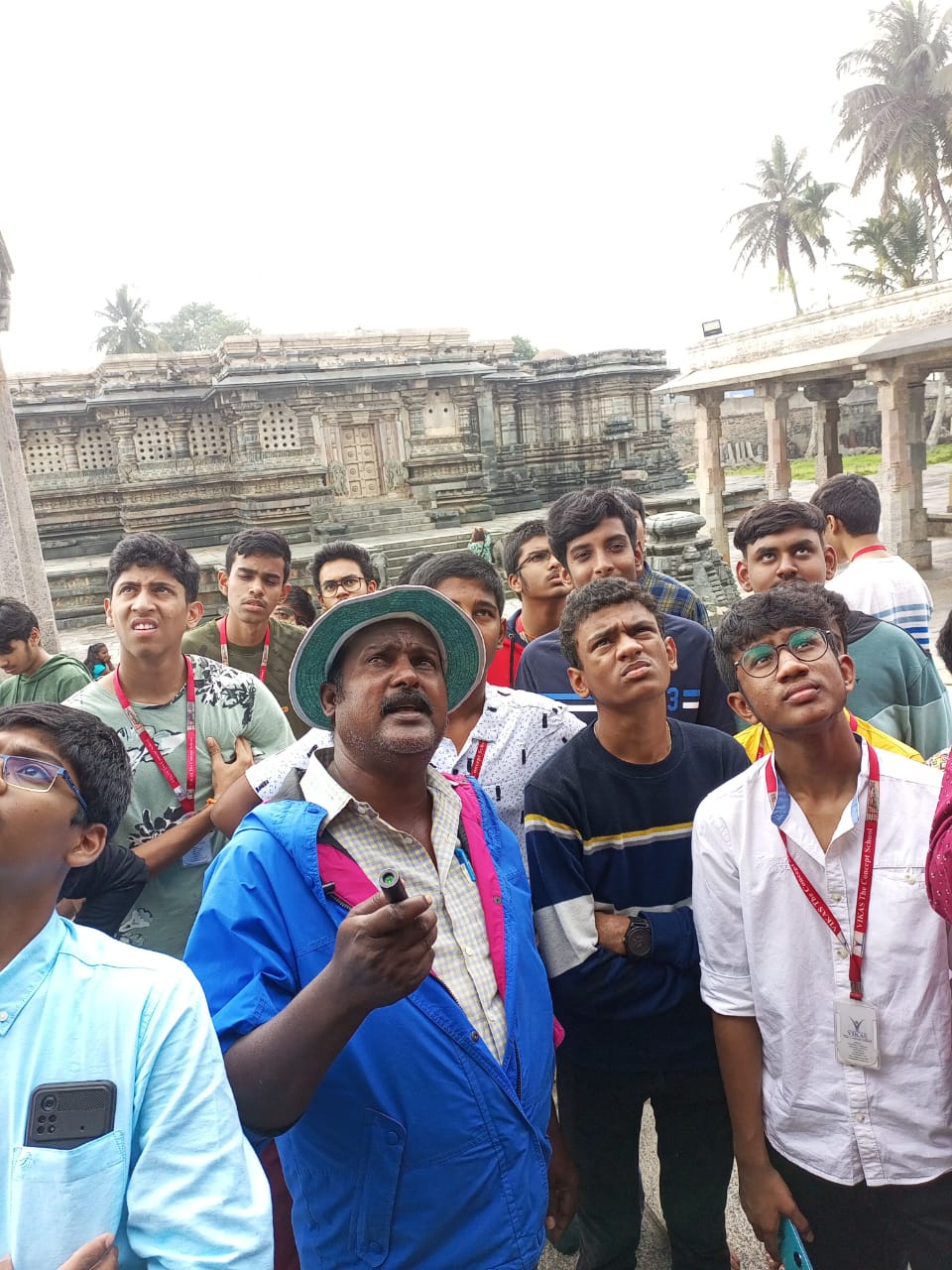 guide explaining about belur temple history